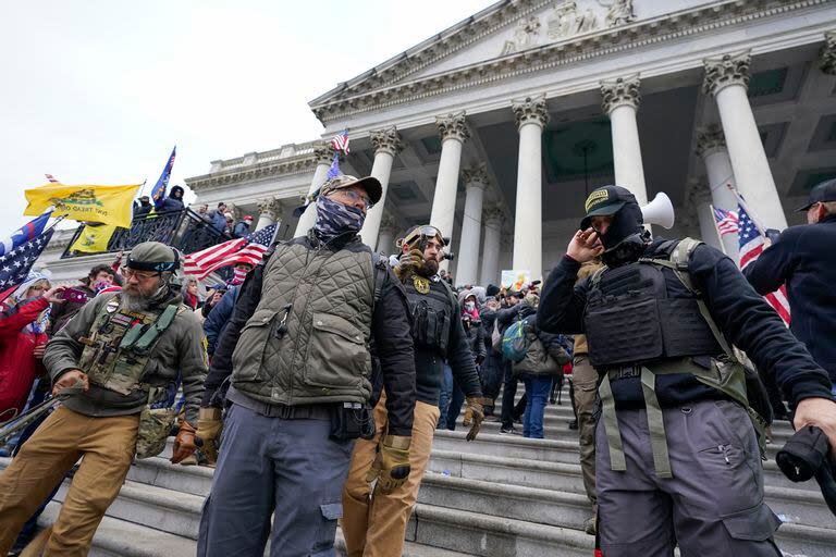 Members of the Oath Keepers pose for a photo in front of the Congressional building on January 6, 2021, after a mob stormed the Capitol.  (AP Photo/Manuel Balse Seneta, File)