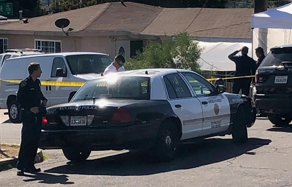 San Diego police investigate the scene of a shooting in Paradise Hills, a San Diego neighborhood, Saturday, Nov. 16, 2019. Police said Saturday that five members of a family, including three young boys, have died and another boy was hospitalized with injuries in an apparent murder-suicide in San Diego. (John Wilkens/The San Diego Union-Tribune via AP)