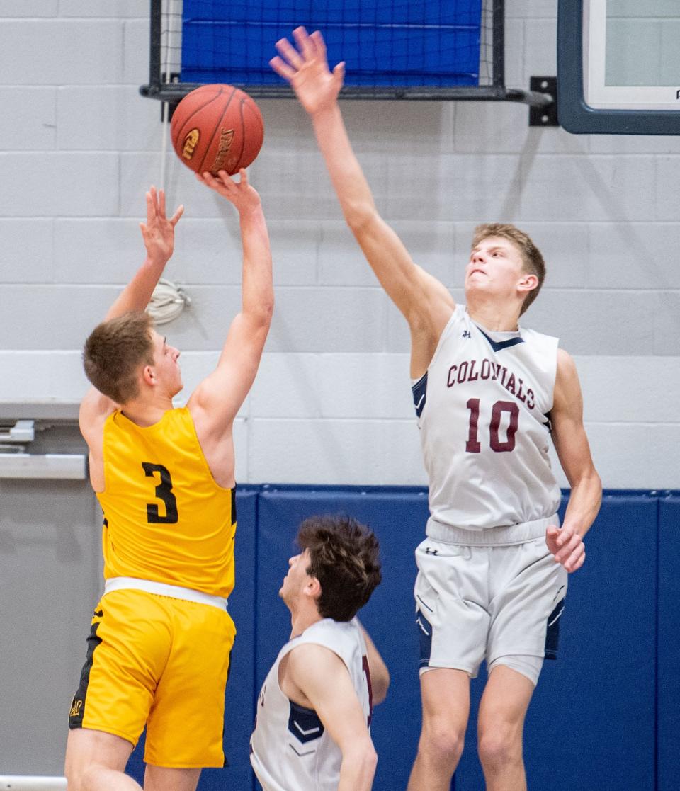 Tommy Haugh (10) looks to block Noah Pierce (3) during the PIAA 5A boys' basketball playoff game between New Oxford and Thomas Jefferson at Dallastown Area High School, March 6, 2020. The Colonials defeated the Jaguars 70-48.