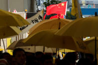 Pro-China supporters wave Chinese national flag as pro-democracy supporters hold yellow umbrellas to support leaders of Occupy Central activists outside the court, in Hong Kong, China April 24, 2019. REUTERS/Tyrone Siu