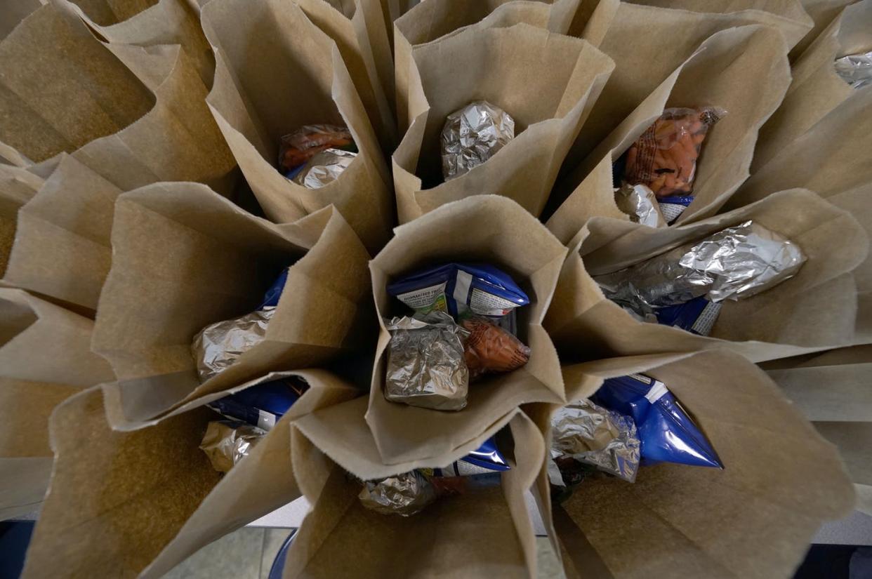 <span class="caption">Free bagged lunches are ready for distribution at a public school in Fayette, Miss., on March 3, 2021.</span> <span class="attribution"><a class="link " href="https://newsroom.ap.org/detail/HungerInAmericaFeedingKids/68ca145edadc43c6bc28ea01a5b8400a/photo" rel="nofollow noopener" target="_blank" data-ylk="slk:AP Photo/Rogelio V. Solis;elm:context_link;itc:0;sec:content-canvas">AP Photo/Rogelio V. Solis</a></span>