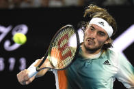 Stefanos Tsitsipas of Greece plays a backhand return to Jannik Sinner of Italy during their quarterfinal match at the Australian Open tennis championships in Melbourne, Australia, Wednesday, Jan. 26, 2022. (AP Photo/Andy Brownbill)