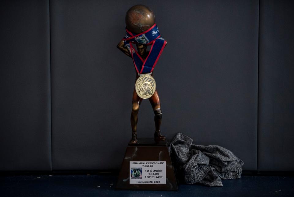 Casey Bittner's first place trophy for the 10 and under, 73 pounds division at the Tulsa Kickoff Classic rests on a mat inside the Daniel Cormier Wrestling Academy in Gilroy, Calif., on Tuesday  Nov. 23, 2021. 