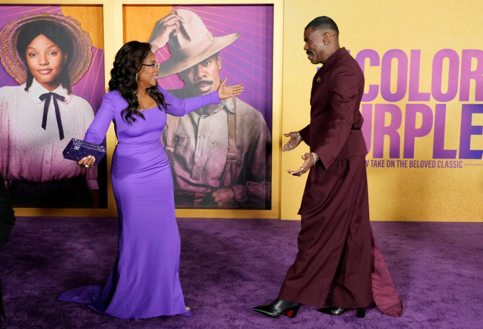 Oprah Winfrey, left, producer of "The Color Purple," is greeted by cast member Colman Domingo at the premiere of the film at the Academy Museum of Motion Pictures, Wednesday, Dec. 6, 2023, in Los Angeles.
