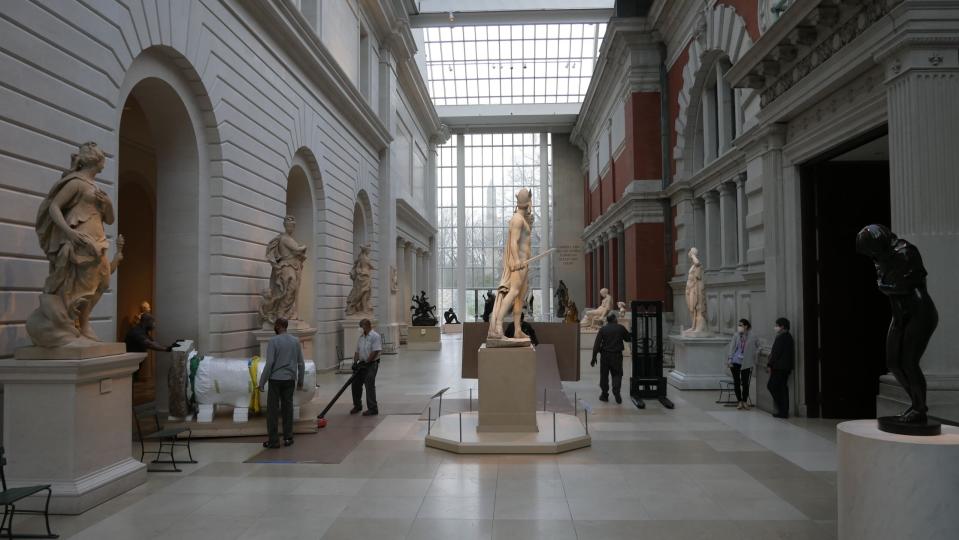 Art handlers move Stone Megalith through the European Sculptures Galleries.