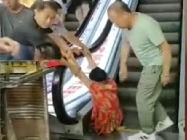 A woman has reportedly had her leg crushed by a moving escalator at a shopping centre in China.Video footage published by a local news agency showed the woman, who is said to be in her sixties, trapped from the waist down after part of the staircase collapsed beneath her.A family member said she had fallen into the machinery when the metal steps gave way without warning at the centre in the northeast city of Harbin.When firefighters freed the woman, who has not been identified, they were forced to sever her left leg below the knee, local media reported.The relative said a number of steps had given way causing the victim to tumble into cogs beneath.They added that she had tried to climb out but had nothing to step on during the ordeal, which local media reported happened on Saturday. The Independent was unable to verify the footage.Other eyewitnesses said the woman had attempted to use the steps while workmen were doing repairs.An unnamed shopkeeper said: “There were barriers all around it. She removed the barriers and stepped onto the escalator. The escalator had just been repaired and was still being tested.”Another woman added: "The step broke as soon as she stepped on it."The victim herself is now said to be in a stable condition after undergoing emergency surgery.The cause of the accident is being investigated by authorities.