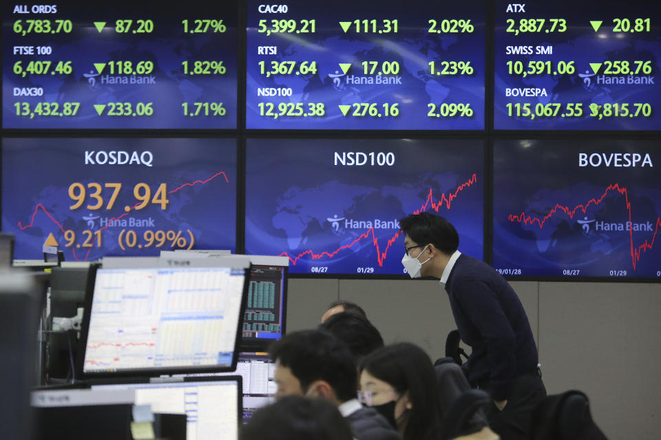 A currency trader watches monitors at the foreign exchange dealing room of the KEB Hana Bank headquarters in Seoul, South Korea, Monday, Feb. 1, 2021. Asian stock markets gained Monday after coronavirus vaccine maker AstraZeneca agreed to increase supplies to Europe amid rising worries about the disease.(AP Photo/Ahn Young-joon)