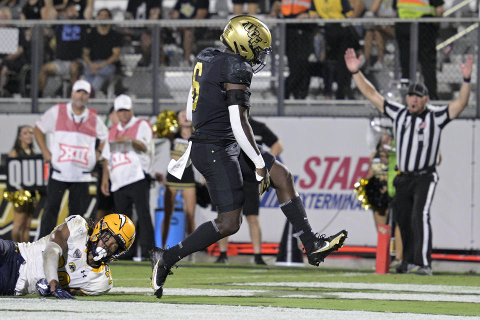 Central Florida running back Mark-Antony Richards (6) rushes for a 7-yard touchdown past Kent State cornerback Alex Branch, left, during the second half of an NCAA college football game, Thursday, Aug. 31, 2023, in Orlando, Fla. (AP Photo/Phelan M. Ebenhack)