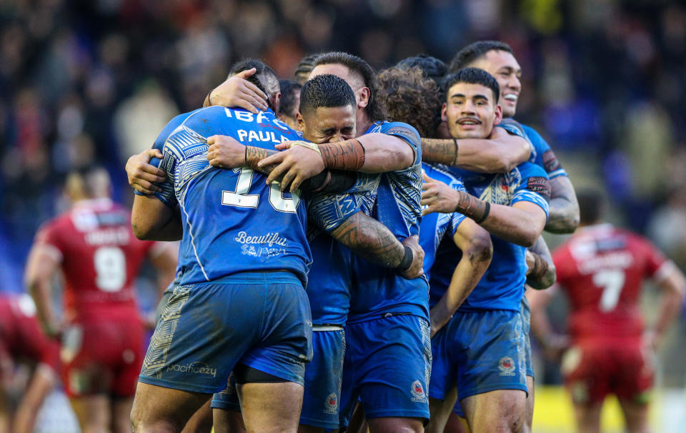 Seen here, the Samoan team celebrates their Rugby League World Cup quarter final victory over Tonga in Warrington. 