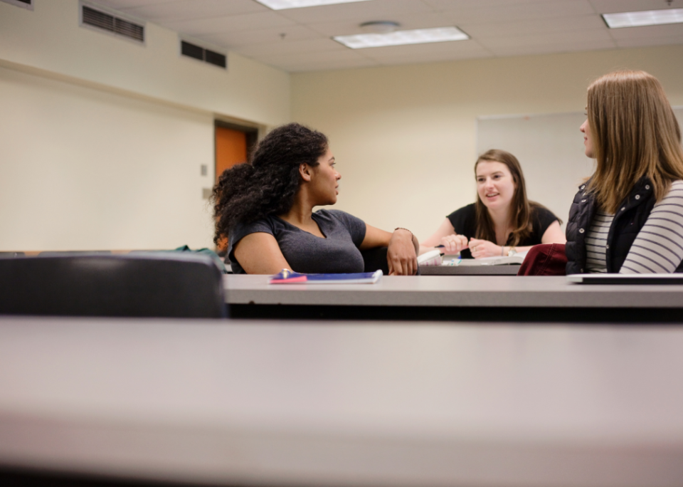 Three students chatting before class.