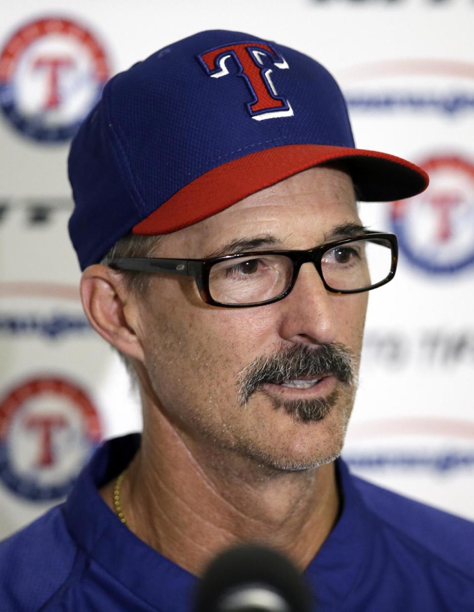 Texas Rangers pitching coach Mike Maddux responds to questions about Yu Darvish's throwing session during spring training baseball practice, Tuesday, Feb. 18, 2014, in Surprise, Ariz. (AP Photo/Tony Gutierrez)