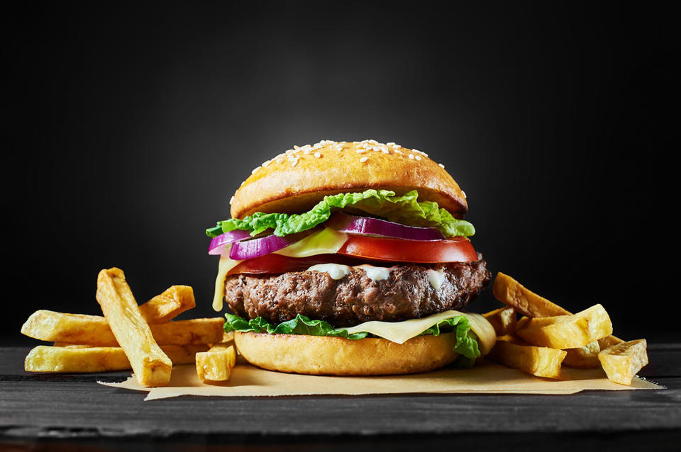 Close-up of home made tasty burger on wooden table.