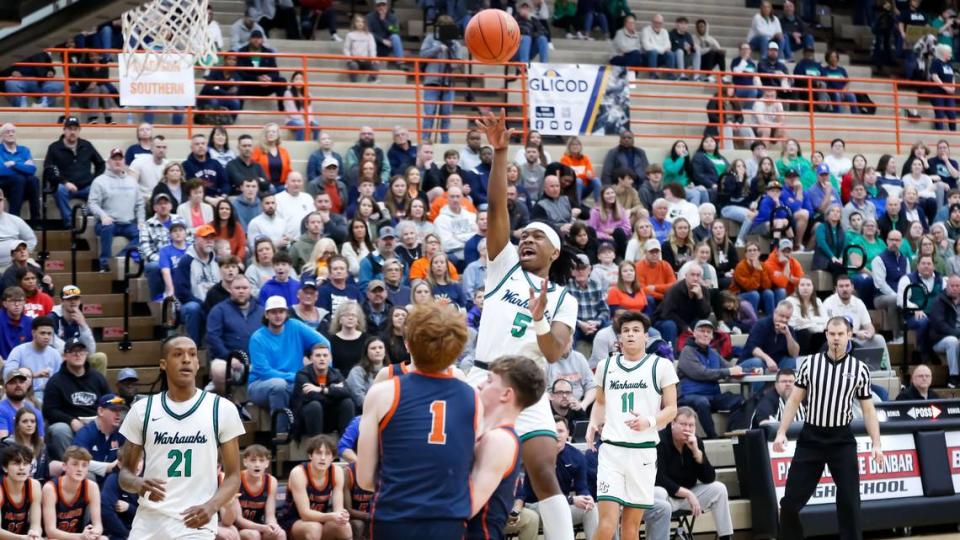 Great Crossing’s Junius Burrell (5) shot a floater in traffic against Madison Southern during the boys 11th Region Tournament semifinals at Paul Laurence Dunbar High School on Saturday.