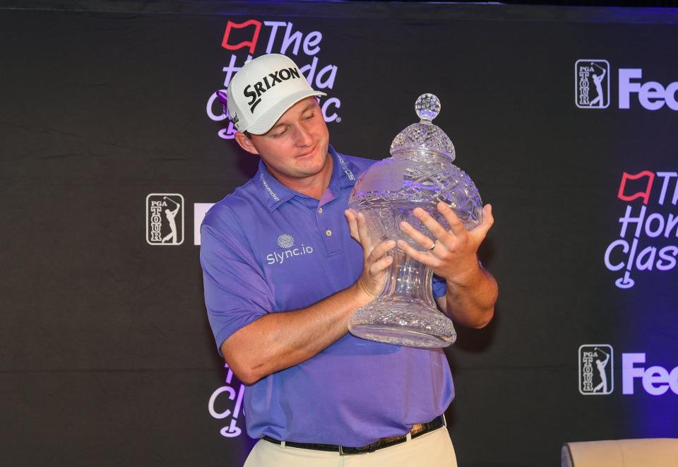 Sepp Straka admires the championship trophy after winning the Honda Classic Sunday at PGA National.