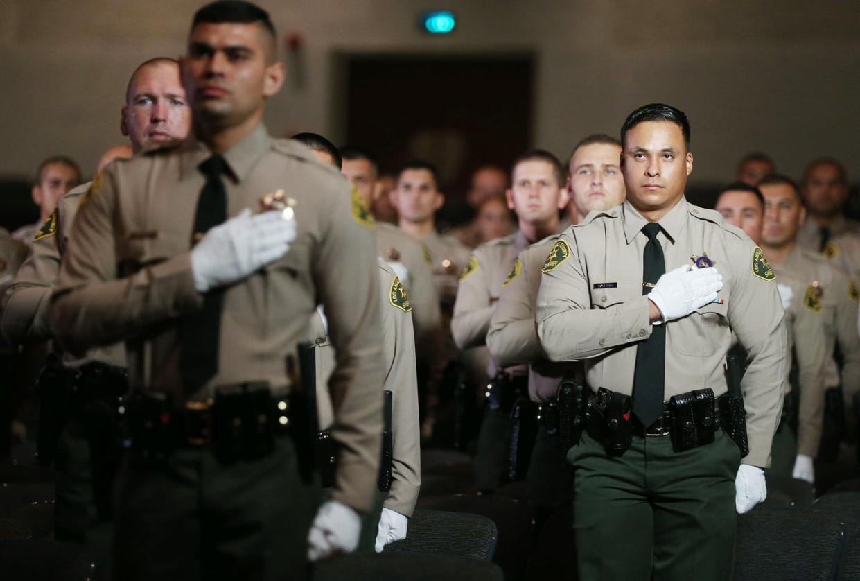 <span class="caption">A Los Angeles County police graduation ceremony, Aug. 21, 2020 in Monterey Park, Calif. </span> <span class="attribution"><a class="link " href="https://www.gettyimages.com/detail/news-photo/graduates-of-los-angeles-county-sheriffs-department-academy-news-photo/1267562794?adppopup=true" rel="nofollow noopener" target="_blank" data-ylk="slk:Mario Tama/Getty Images;elm:context_link;itc:0;sec:content-canvas">Mario Tama/Getty Images</a></span>