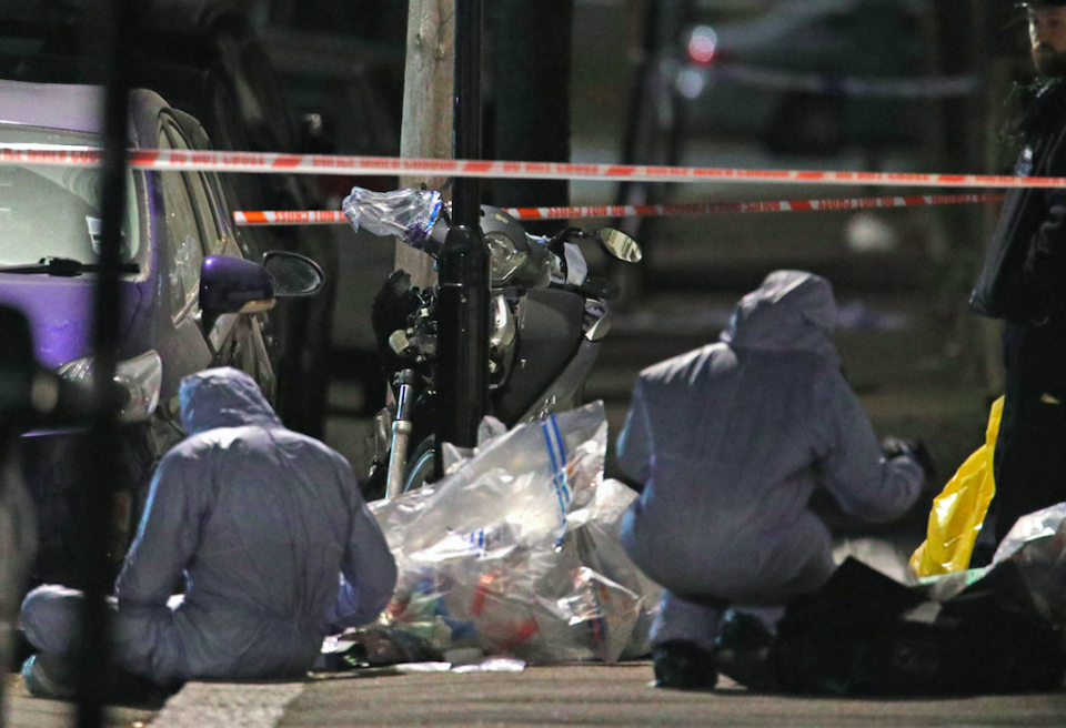 <em>Forensic officers look for clues following the stabbing (PA)</em>