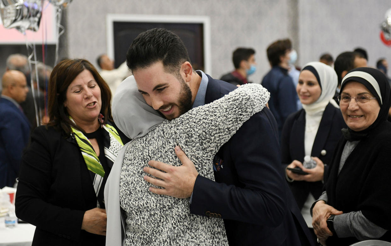 Dearborn mayor candidate Abdullah Hammoud hugs family members at the Mohammed Turfe Community Center in Dearborn, Mich.