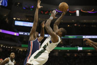 Milwaukee Bucks' Eric Bledsoe shoots against Washington Wizards during during the second half of an NBA basketball game Tuesday, Jan. 28. 2020, in Milwaukee. (AP Photo/Jeffrey Phelps)