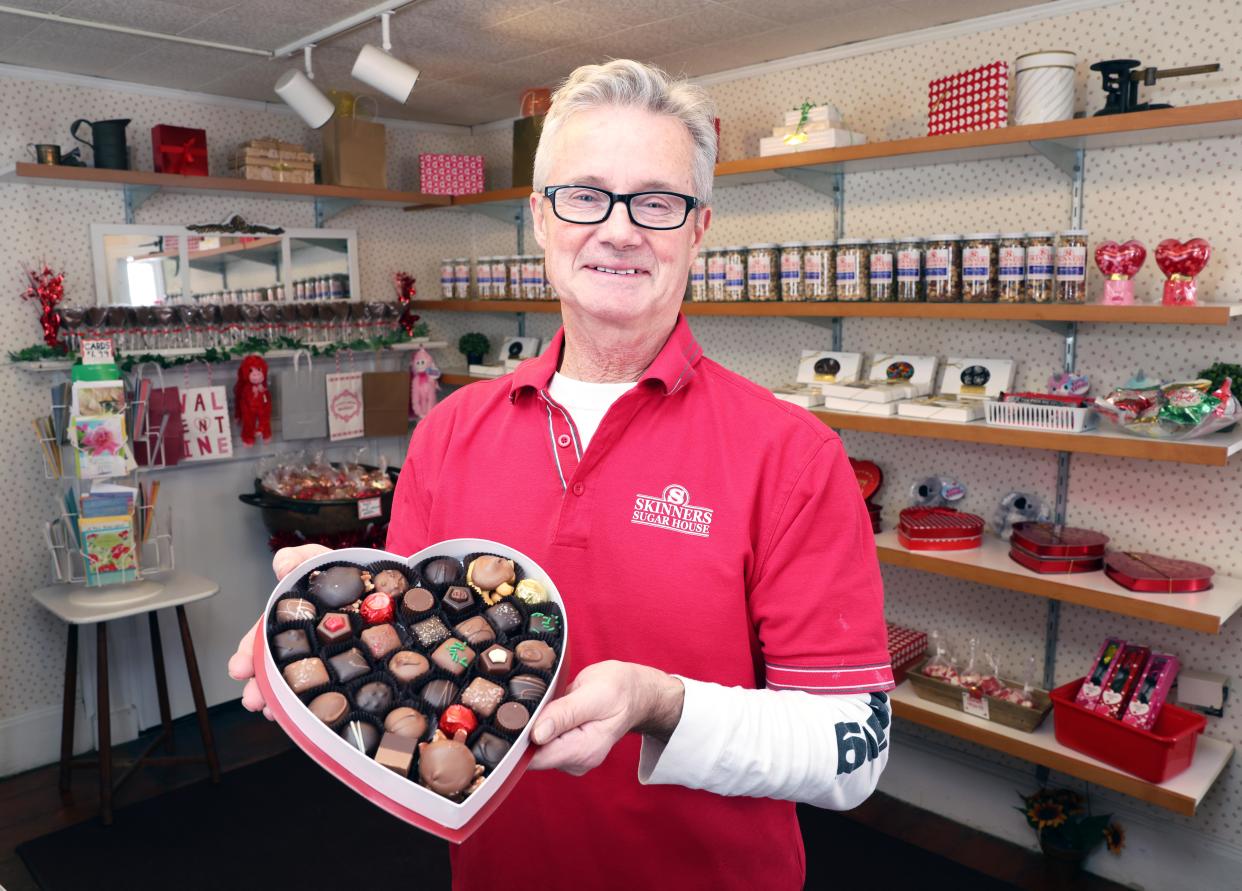 Owner Paul Daley holds an assortment of candy in a heart shaped box sold at Skinners Sugar House in East Bridgewater on Thursday, Jan. 18, 2024.