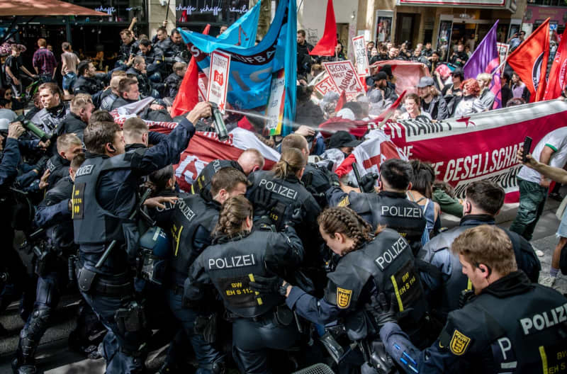 Police units clash with demonstrators during the Revolutionary May Day demonstration in Stuttgart city center. Christoph Schmidt/dpa