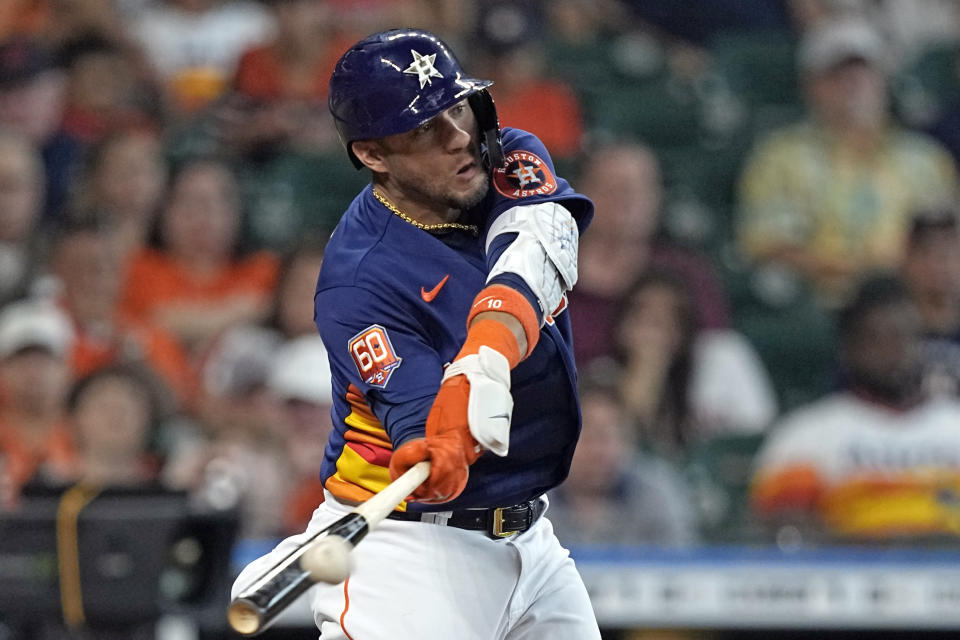 Houston Astros' Yuli Gurriel hits a RBI-double against the Texas Rangers during the fifth inning of a baseball game Sunday, May 22, 2022, in Houston. (AP Photo/David J. Phillip)