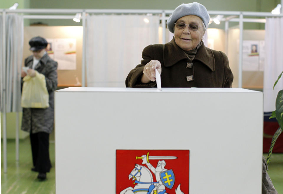 An elderly woman votes at a polling station in Vilnius, Lithuania, Sunday, Oct. 28, 2012. Lithuanians balloted Sunday in a second round of parliamentary elections. (AP Photo/Mindaugas Kulbis)