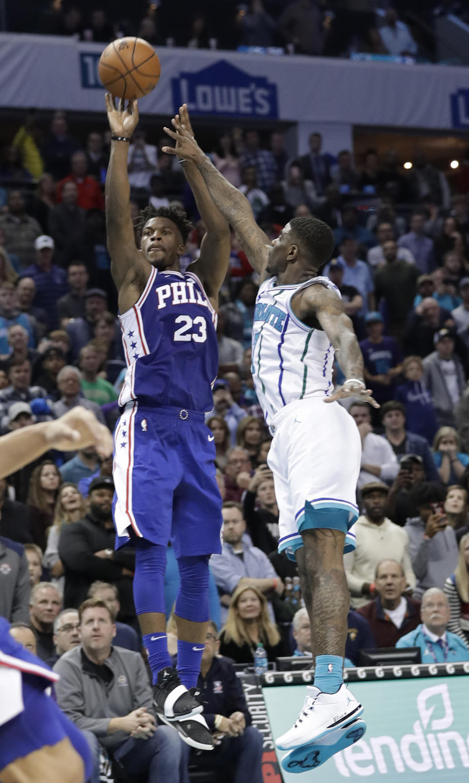 Philadelphia 76ers' Jimmy Butler (23) shoots the game-winning basket next to Charlotte Hornets' Dwayne Bacon (7) during overtime of an NBA basketball game in Charlotte, N.C., Saturday, Nov. 17, 2018. (AP Photo/Chuck Burton)