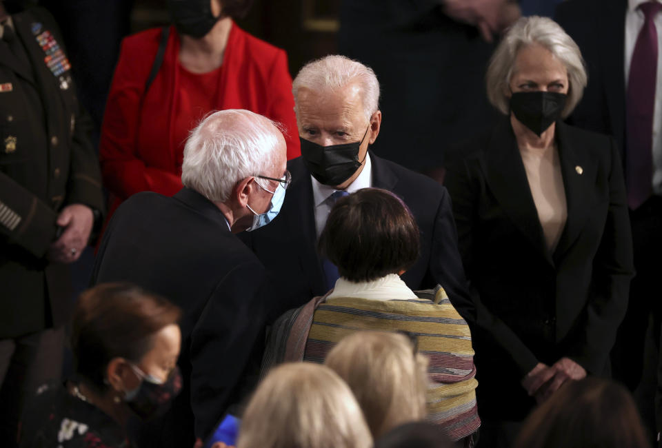 President Joe Biden speaks with Sen. Bernie Sanders, I-Vt., left, after addressing a joint session of congress in the House chamber of the U.S. Capitol on April 28, 2021, in Washington, (Chip Somodevilla/Pool via AP