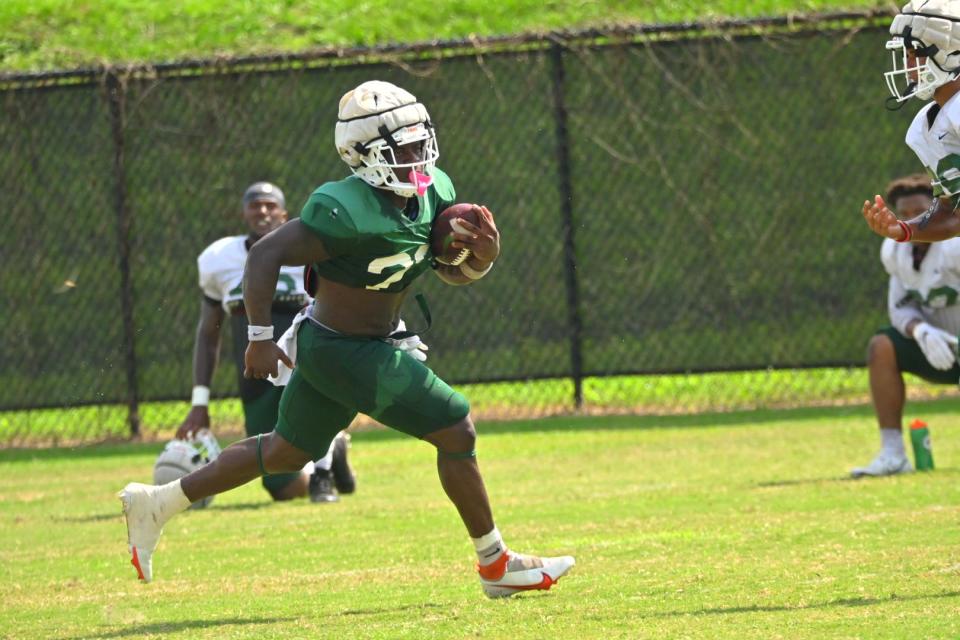 Florida A&M University running back Terrell Jennings (with ball) breaks away for a run in fall training camp practice, Aug. 16, 2022