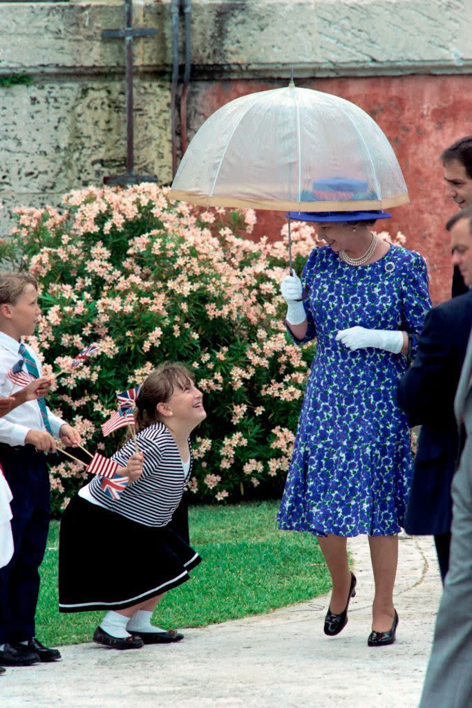 <p>A young fan tries to get in on the Queen's umbrella action.<br></p>