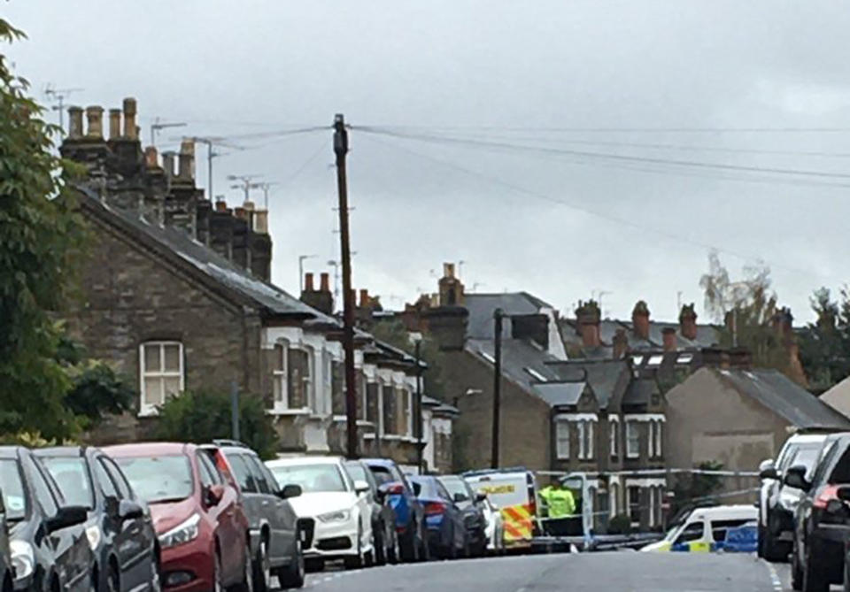 A police cordon on the street where the three bodies were found. (PA)