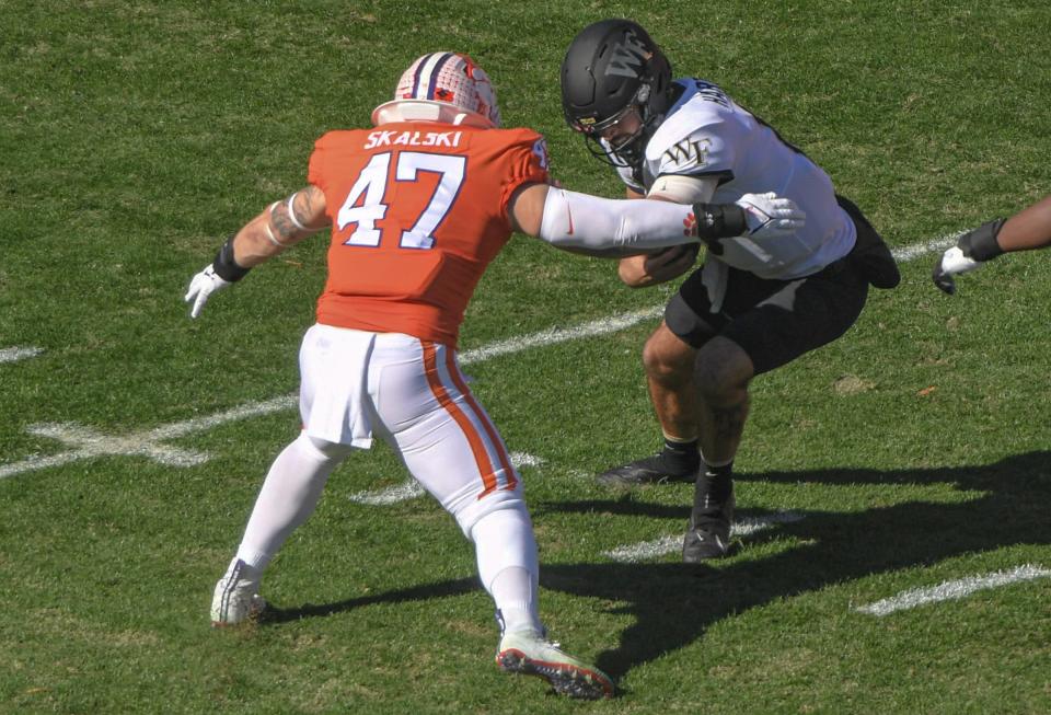 Clemson linebacker James Skalski (47) sacks Wake Forest quarterback Sam Hartman (10) during the first quarter at Memorial Stadium in Clemson, South Carolina Saturday, November 20, 2021.