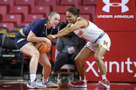 Maryland guard Katie Benzan, right, reaches for the ball held by Mount St. Mary's forward Isabella Hunt during the second half of an NCAA college basketball game Tuesday, Nov. 16, 2021, in College Park, Md. Maryland won 98-57. (AP Photo/Nick Wass)