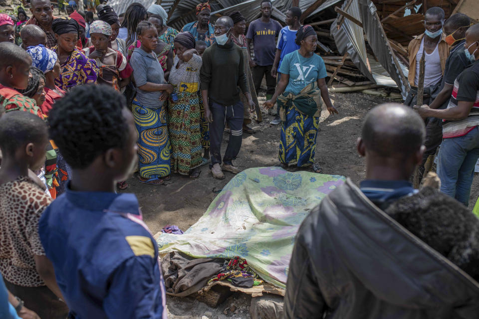 Villagers gather to identify victims in the village of Nyamukubi, South Kivu province, in Congo, Saturday, May 6, 2023. The death toll from flash floods and landslides in eastern Congo has risen according to the governor and authorities in the country's South Kivu province. (AP Photo/Moses Sawasawa)