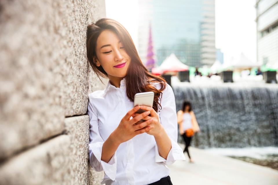 A person uses a smartphone outside.