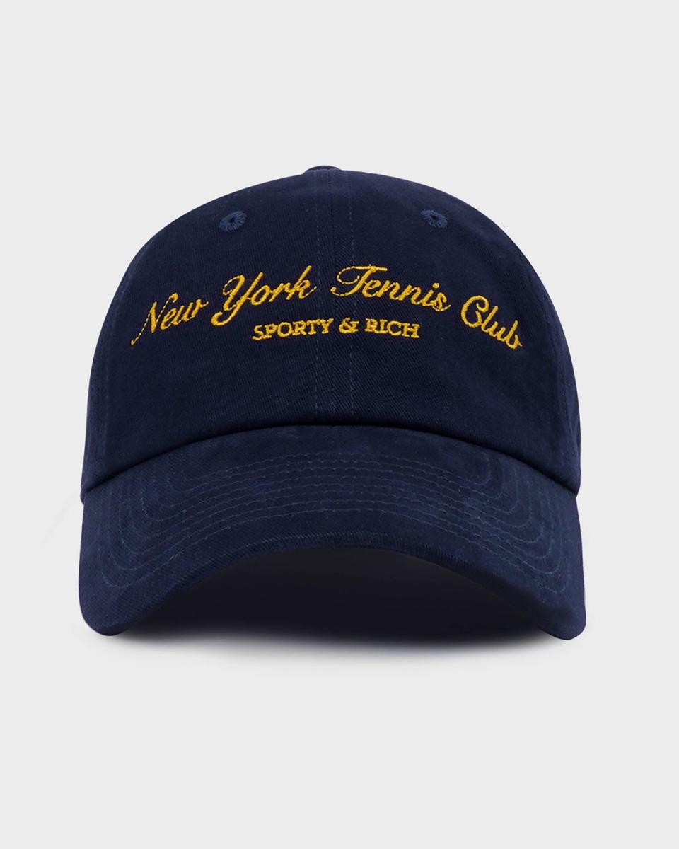 <p><a href="https://www.sportyandrich.com/collections/tennis-drop-ss24/products/ny-tennis-club-embroidered-hat-navy-gold" rel="nofollow noopener" target="_blank" data-ylk="slk:Shop Now;elm:context_link;itc:0;sec:content-canvas" class="link ">Shop Now</a></p><p>NY Tennis Club Hat</p><p>Sporty and Rich</p><p>$60.00</p>
