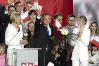 Incumbent President Andrzej Duda flashes a victory sign in Pultusk, Poland, Sunday, July 12, 2020. An exit poll in Poland's presidential runoff election shows a tight race that is too close to call between the conservative incumbent, Andrzej Duda, and the liberal Warsaw mayor, Rafal Trzaskowski.(AP Photo/Czarek Sokolowski)