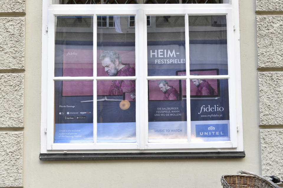 A poster with pictures of Placido Domingo in Salzburg, Austria, Wednesday, Aug. 14, 2019 where singer Placido Domingo will perfom 'Luisa Miller' by Giuseppe Verdi. Numerous women have told The Associated Press that celebrated opera superstar Placido Domingo tried to pressure them into sexual relationships by dangling jobs and sometimes punishing them when they refused his advances. (AP Photo/Kerstin Joensson)