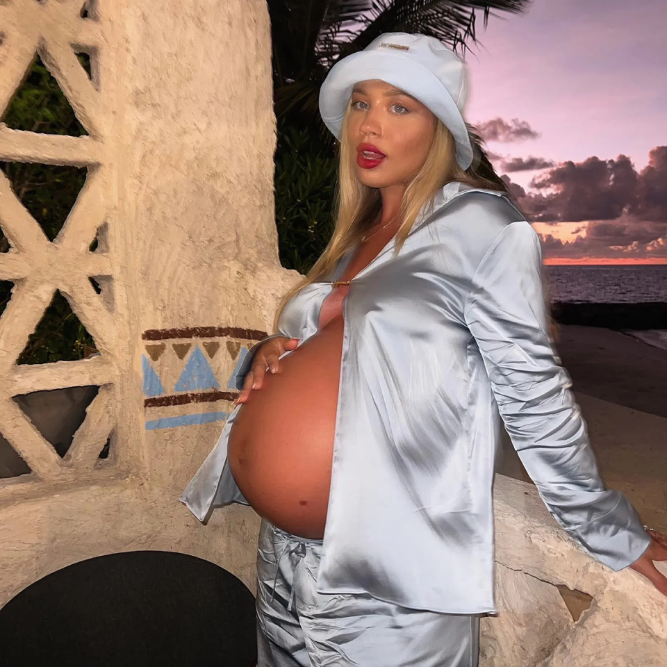 Tammy Hembrow cradling her baby bump.