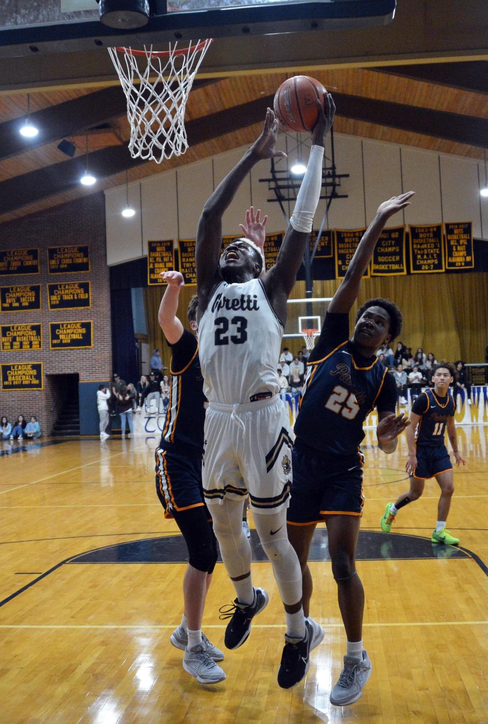 St. Maria Goretti's Caleb Embeya gets inside the Virginia Academy defense for a layup attempt.