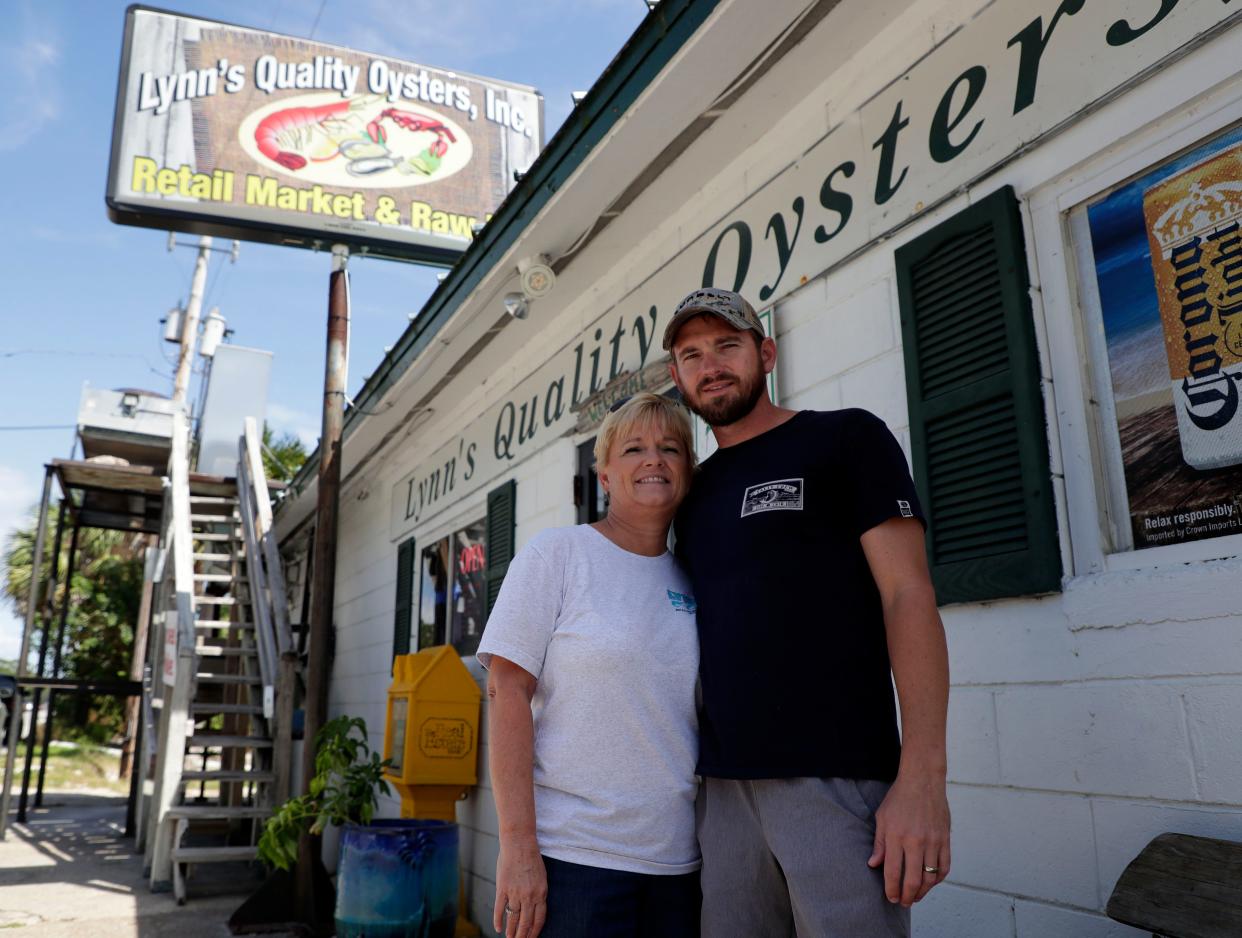 Lynn Martina, left, and her son Brandon Martina pose for a photo outside Lynn's Quality Oysters located in Apalachicola, Florida. 