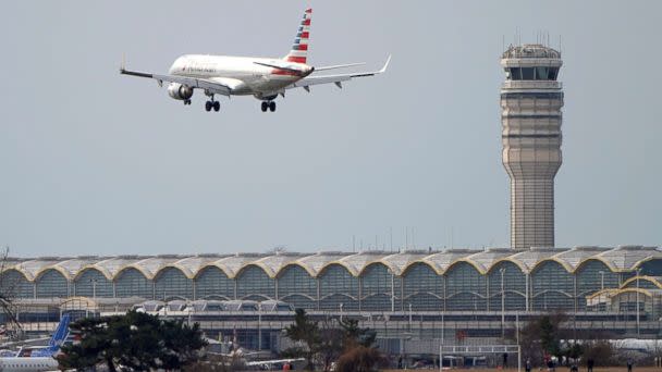 PHOTO: In this Jan. 12, 2019, file photo, an airplane flies past the tower where air traffic controllers work at Reagan National Airport in Washington, D.C. (Joshua Roberts/Reuters, FILE)