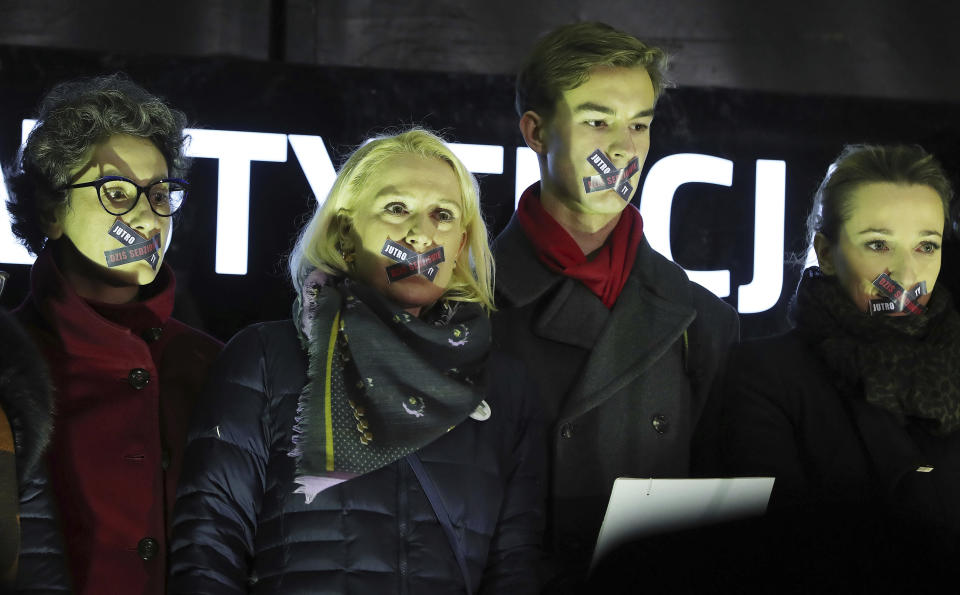 Demonstrators hold a rally to protest against changes to Poland's judiciary planned by the ruling Law and Justice party near the building of parliament in Warsaw, Poland, Wednesday, Dec. 18, 2019. (AP Photo/Czarek Sokolowski)