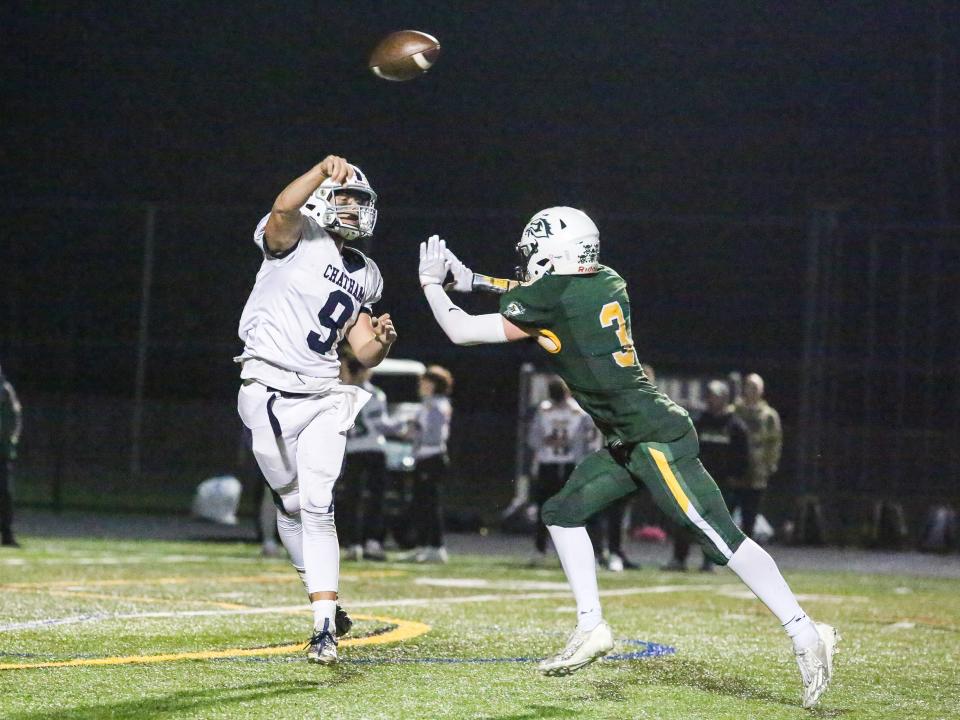 Chatham's QB Jackson Hodges throws a pass as Montville's Jimmy Conlon defends during the first half of a football game at Montville High School on October 20, 2023.
