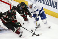 Tampa Bay Lightning center Anthony Cirelli (71) works against Arizona Coyotes defenseman Oliver Ekman-Larsson (23) and center Nick Schmaltz (8) for the puck during the second period of an NHL hockey game Saturday, Feb. 22, 2020, in Glendale, Ariz. (AP Photo/Ross D. Franklin)