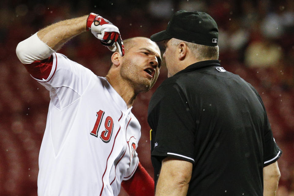 FILE - Cincinnati Reds' Joey Votto (19) argues with umpire Bill Welke after being thrown out of the game for arguing balls and strikes during the eighth inning of a baseball game against the Pittsburgh Pirates, Wednesday, Sept. 9, 2015, in Cincinnati. Automatic balls and strikes could soon be coming to the major leagues. Disappearing with that are the complaints that an umpire’s strike zone was too wide or a pitcher was getting squeezed, followed by the helmet-slamming, dirt-kicking dustups that are practically as old as the sport itself. (AP Photo/John Minchillo, File)