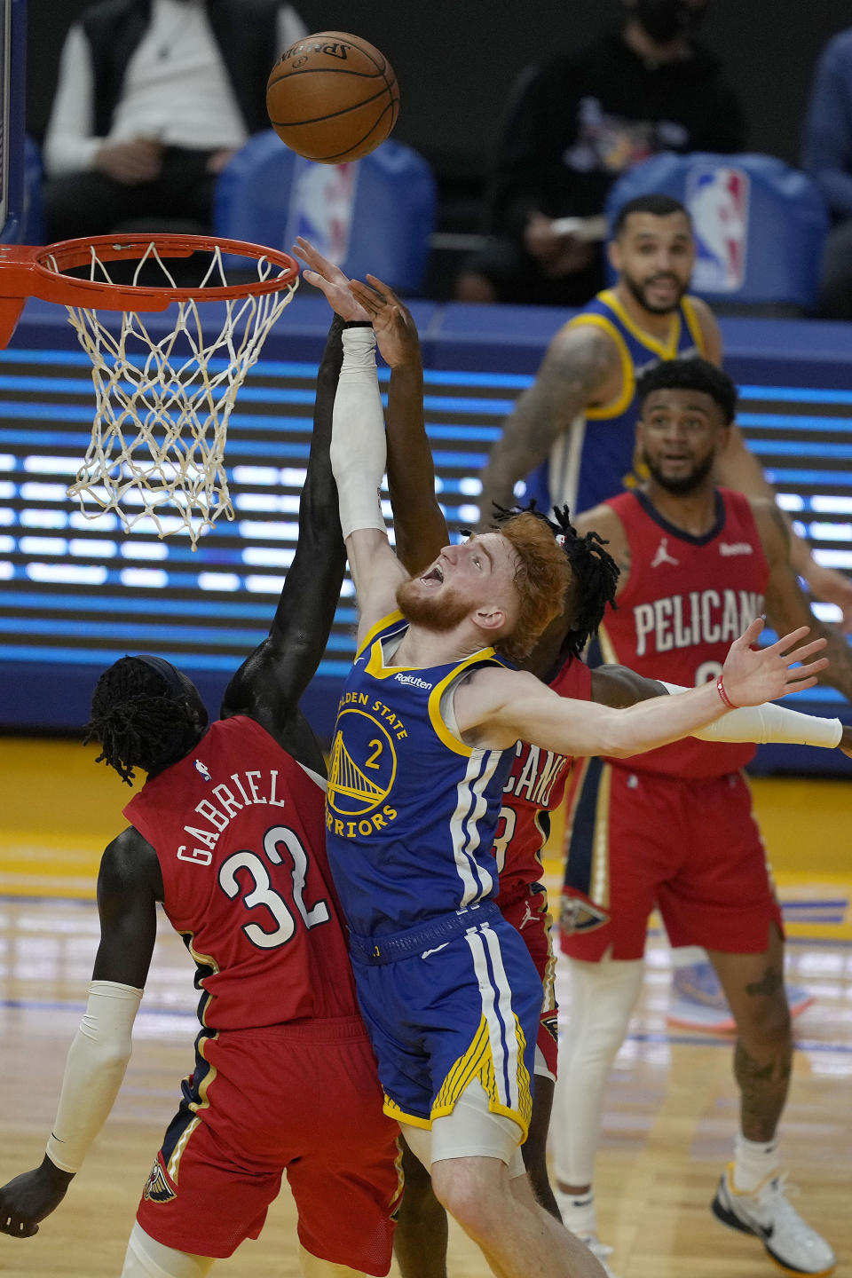 Golden State Warriors' Nico Mannion (2) reacts as he fouled by New Orleans Pelicans forward Wenyen Gabriel (32) during the first half of an NBA basketball game on Friday, May 14, 2021, in San Francisco. (AP Photo/Tony Avelar)