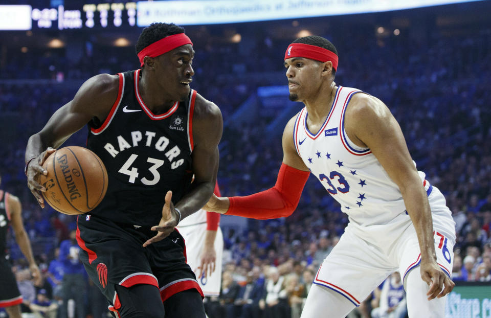 Toronto Raptors' Pascal Siakam, left, looks to make a move against Philadelphia 76ers' Tobias Harris during the first half of Game 3 of a second-round NBA basketball playoff series Thursday, May 2, 2019, in Philadelphia. (AP Photo/Chris Szagola)