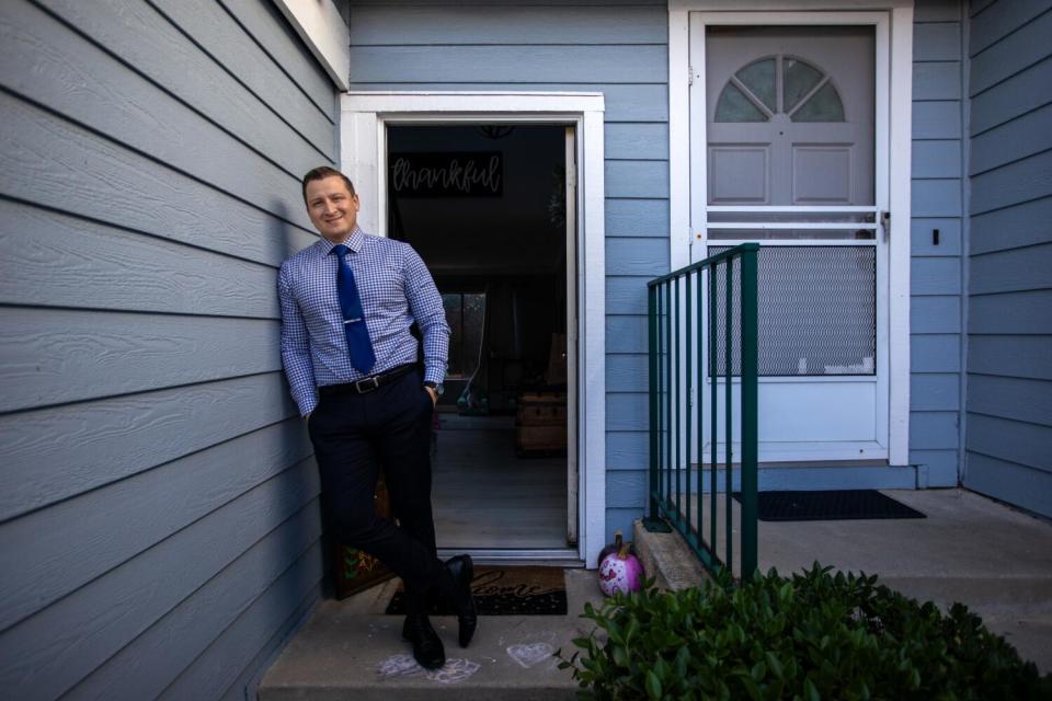 Nicholas Uribe stands outside his home