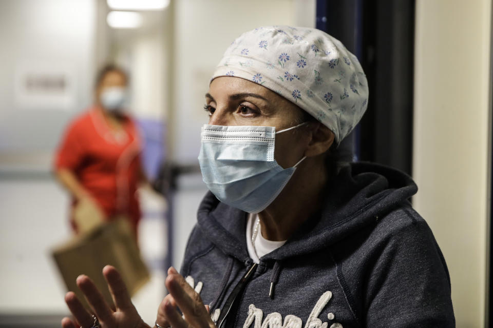 Nurse Cristina Settembrese talks during an interview with the Associated Press outside the intensive care unit after finishing a night shift, at the San Paolo hospital, in Milan, Italy, Thursday, Oct. 15, 2020. (AP Photo/Luca Bruno)